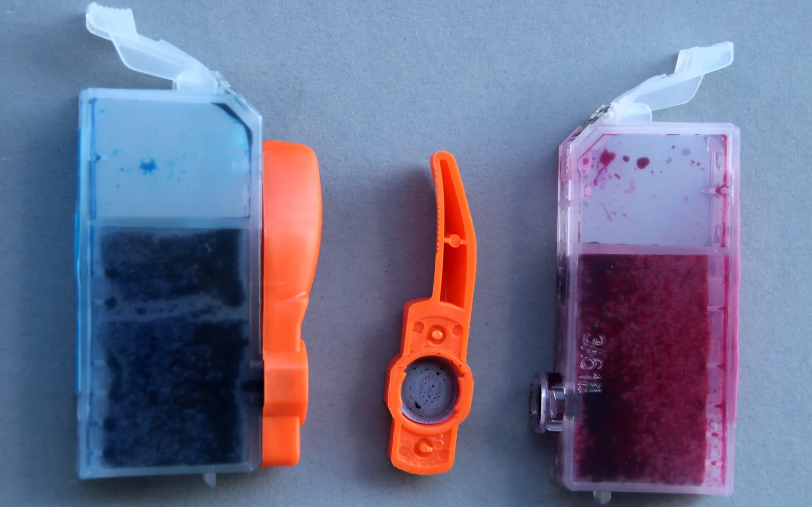 Inkjet ink cartridges in different colours laid out side by side