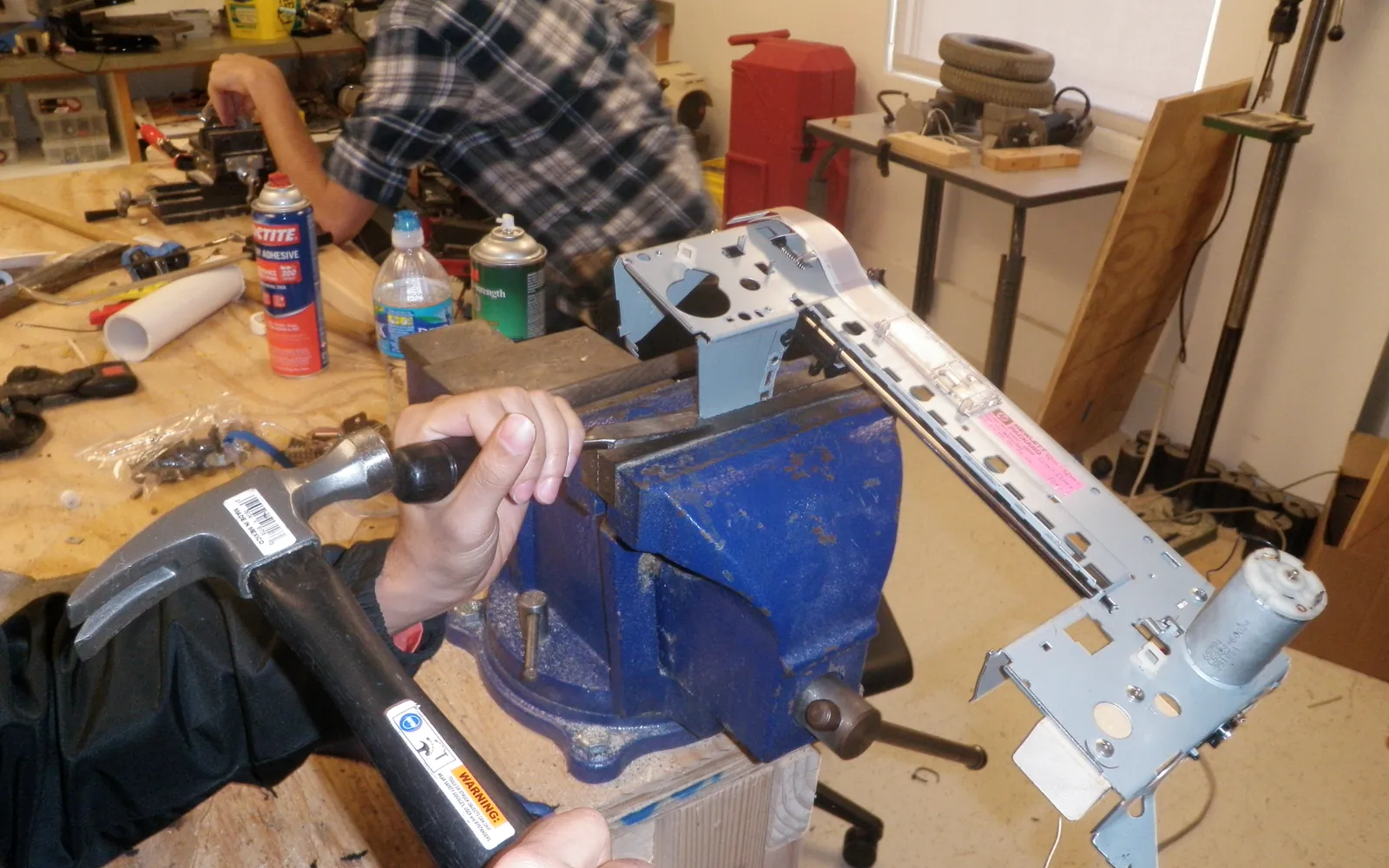 Printer on a workbench with its covers open during troubleshooting